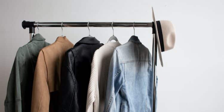 one cowboy hat and five jackets hanged on clothes rack